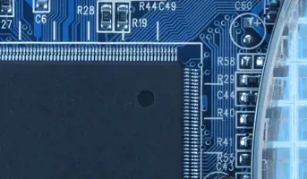 Clost up of blue circuit board and semiconductor wafer